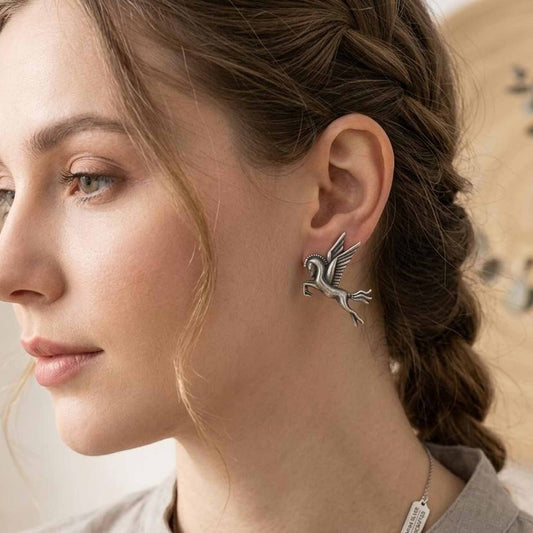 Woman wearing Pegasus winged horse statement earrings