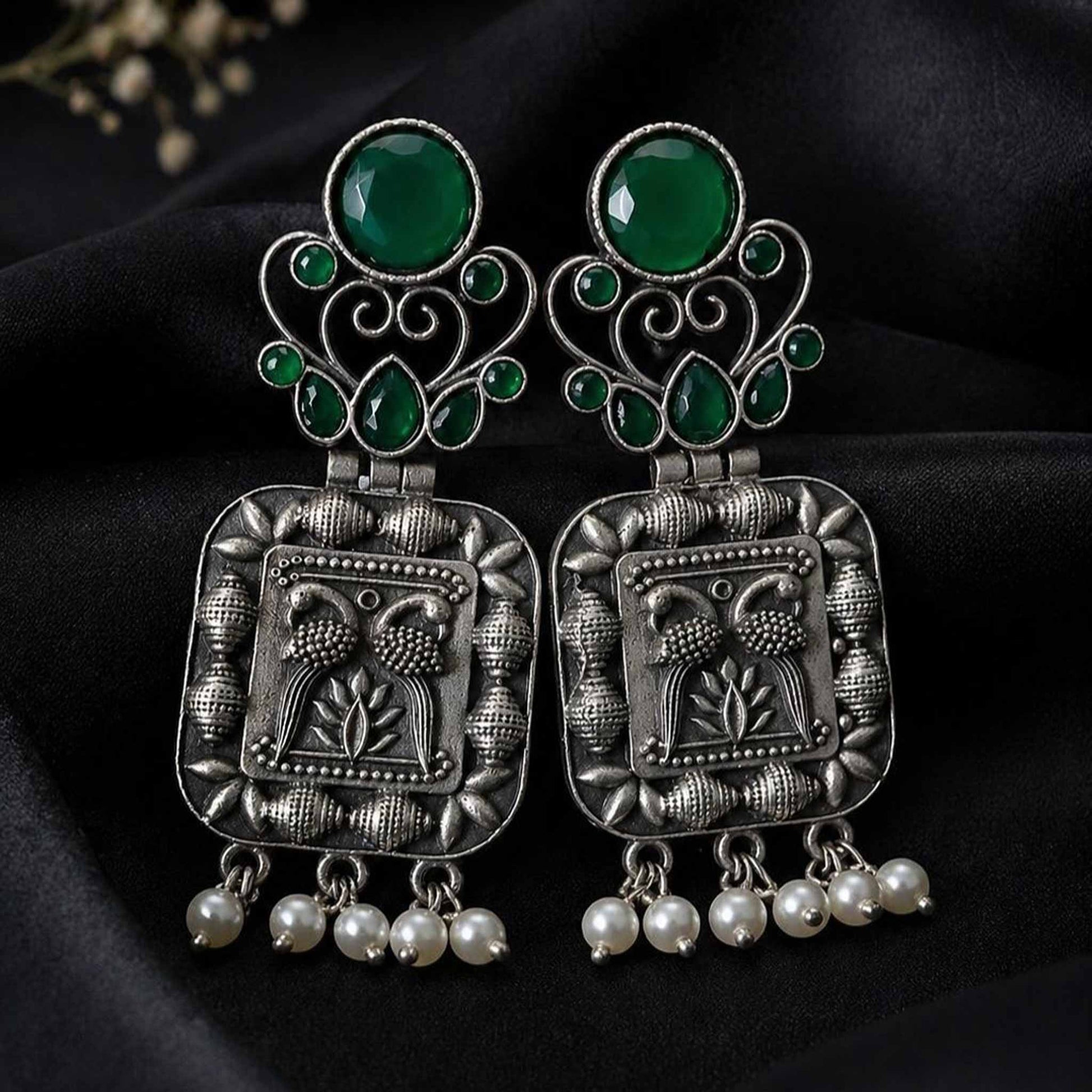 Green stone German silver pearl earrings on black fabric