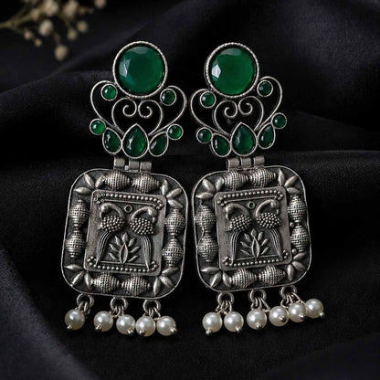 Green stone German silver pearl earrings on black fabric