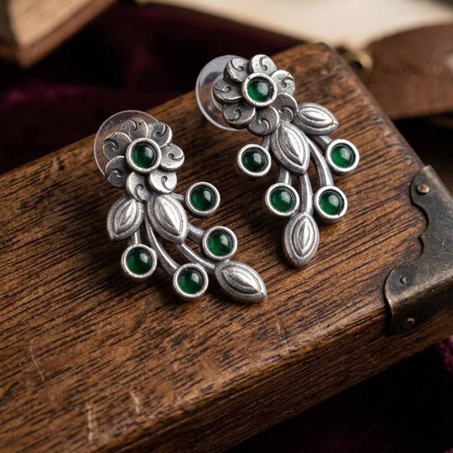 Closeup product display of green floral vine earrings