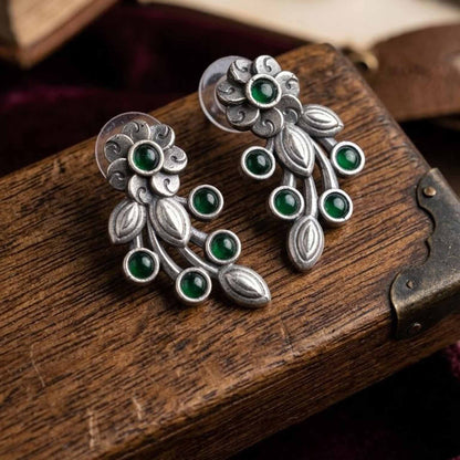 Closeup product display of green floral vine earrings