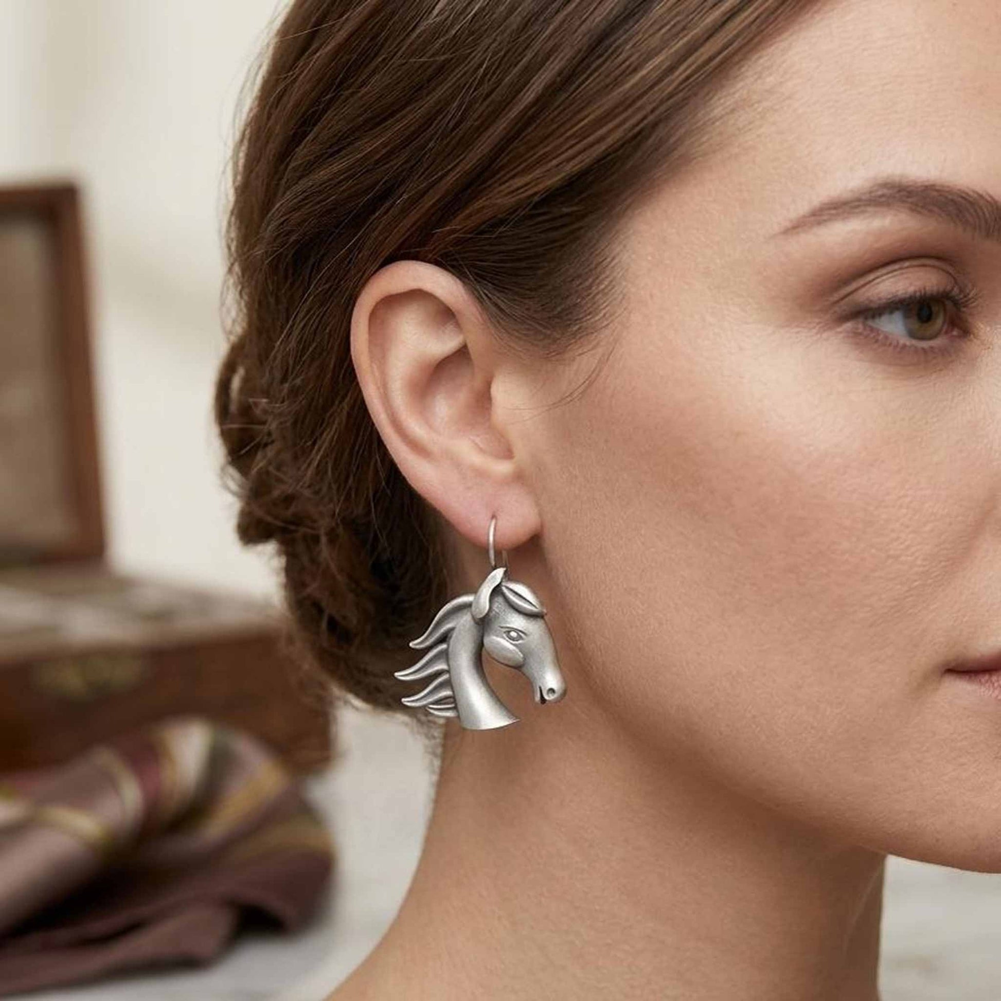 Woman wearing horse head German silver earrings side profile