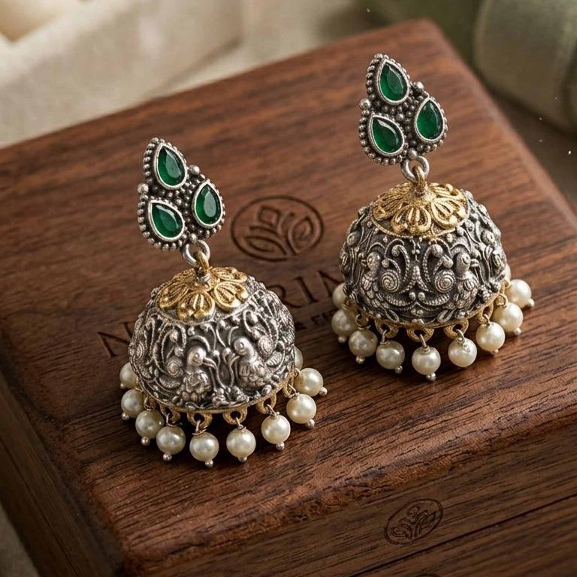 Pair of peacock embossed jhumka earrings