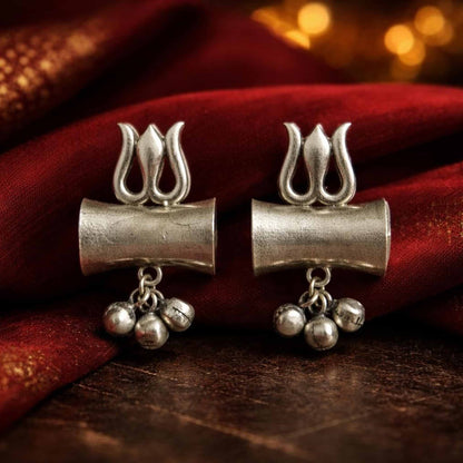 German Silver trishul damru earrings on red fabric