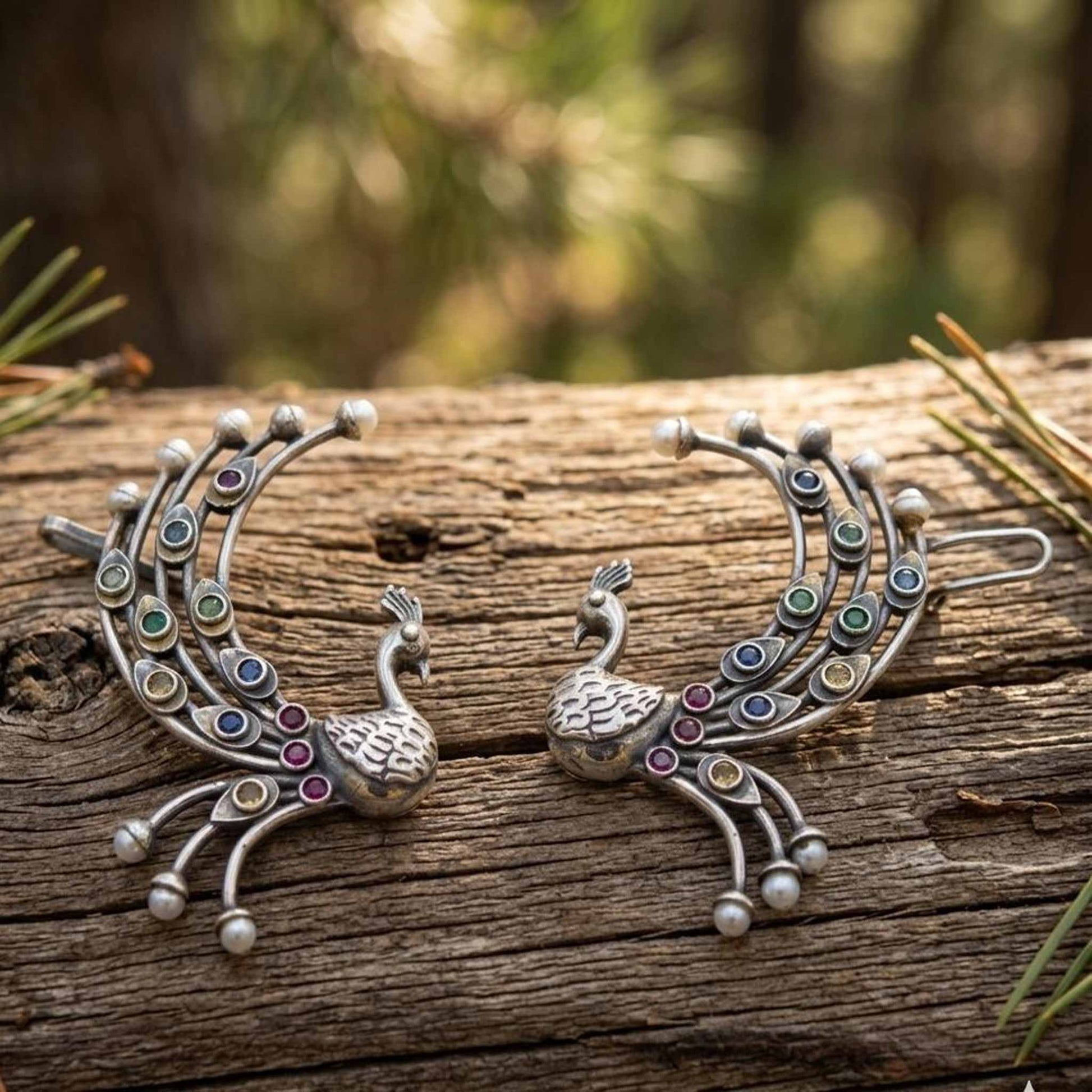 Traditional peacock ear cuff earrings on wooden texture