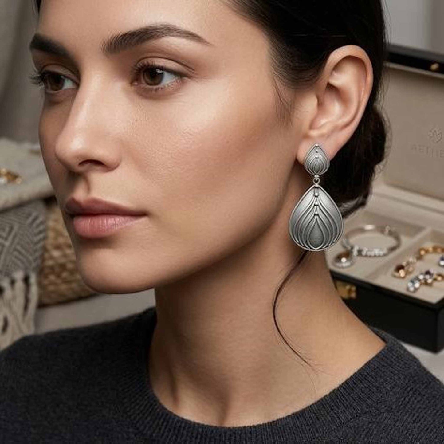 Woman wearing lotus drop German silver earrings