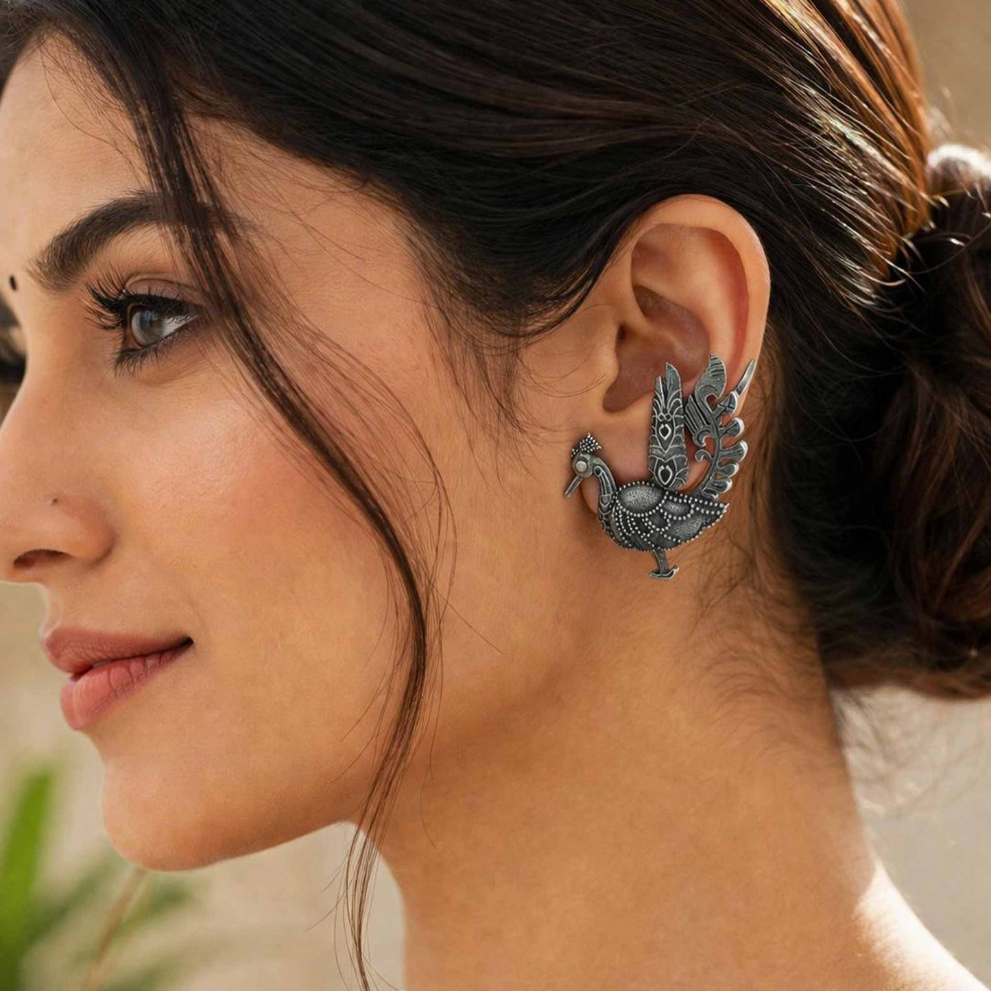 Model wearing German Silver peacock ear cuff earrings