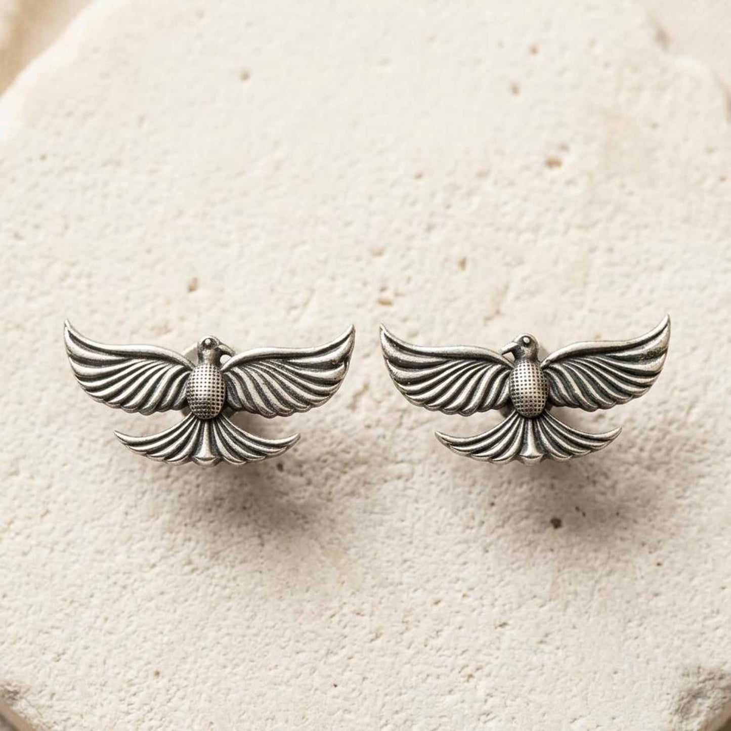 Minimal silver bird earrings product flatlay image