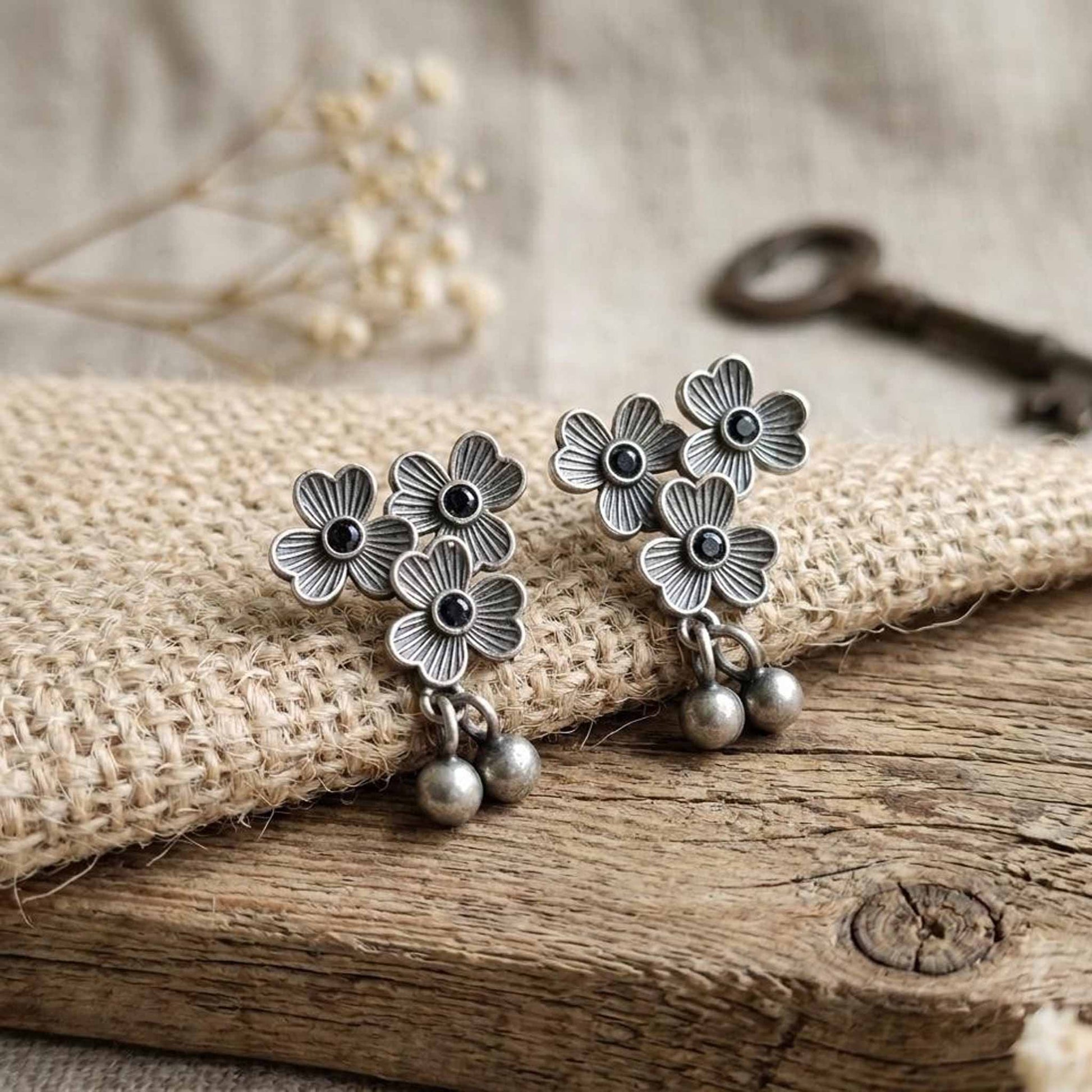 Rustic styled three flower German silver earrings with dangling beads