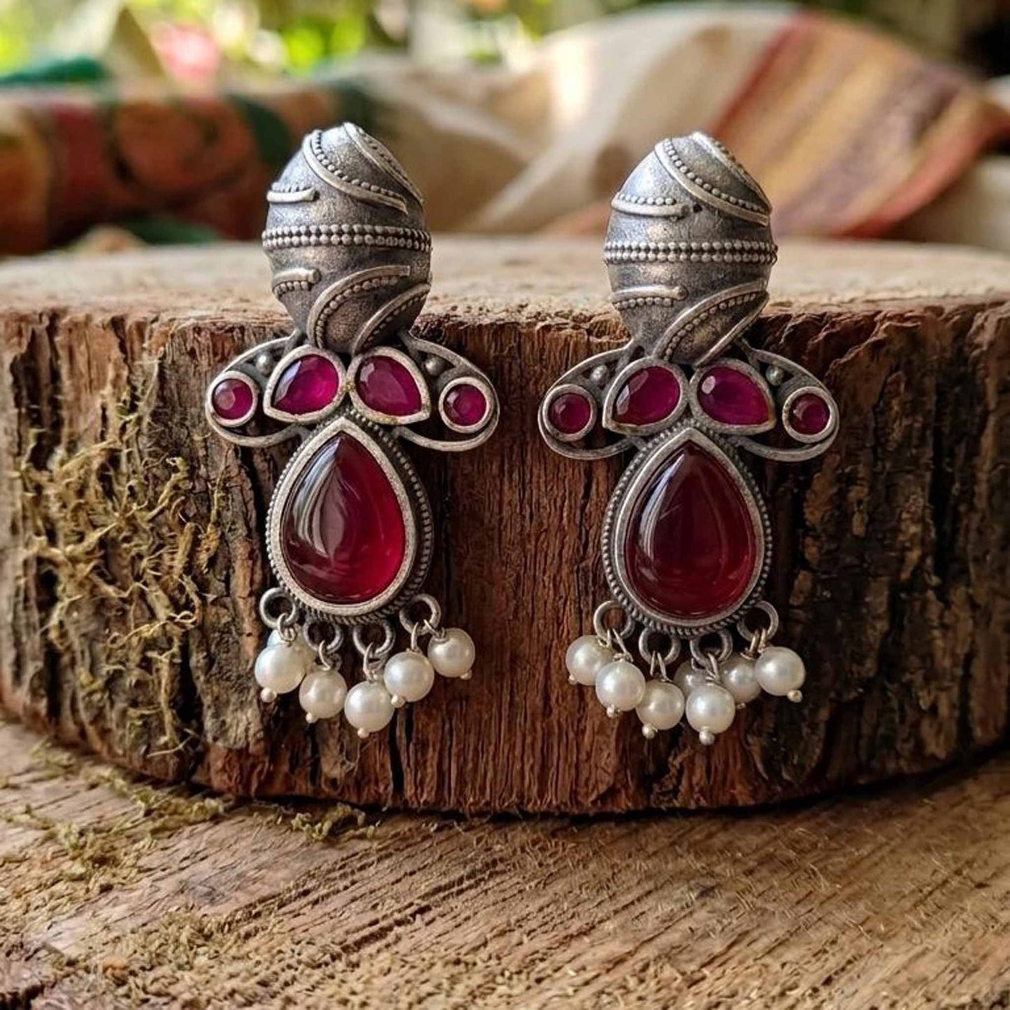 Traditional German Silver ruby earrings on wooden base