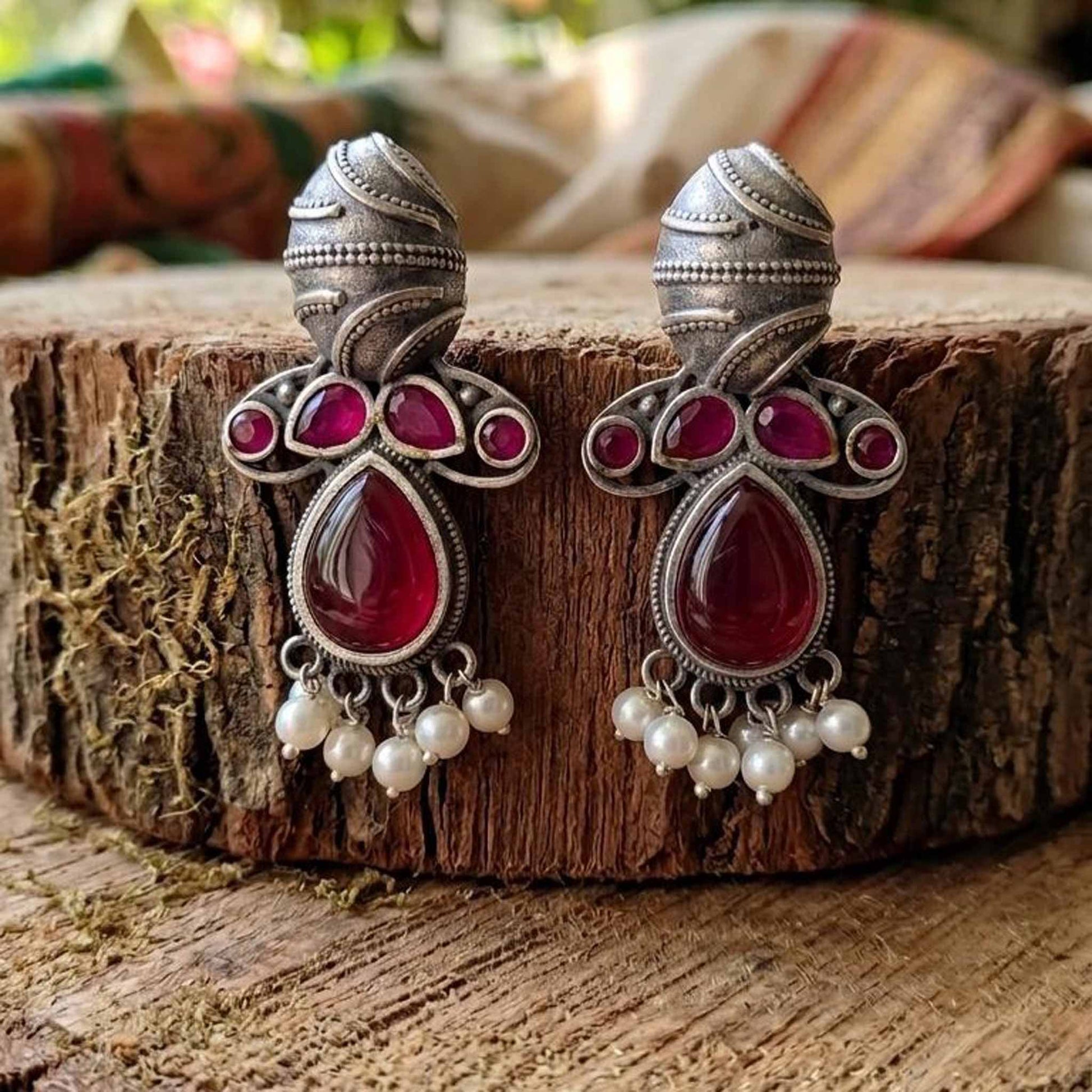 Traditional German Silver ruby earrings on wooden base