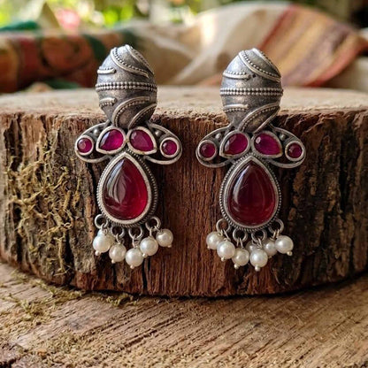 Traditional German Silver ruby earrings on wooden base