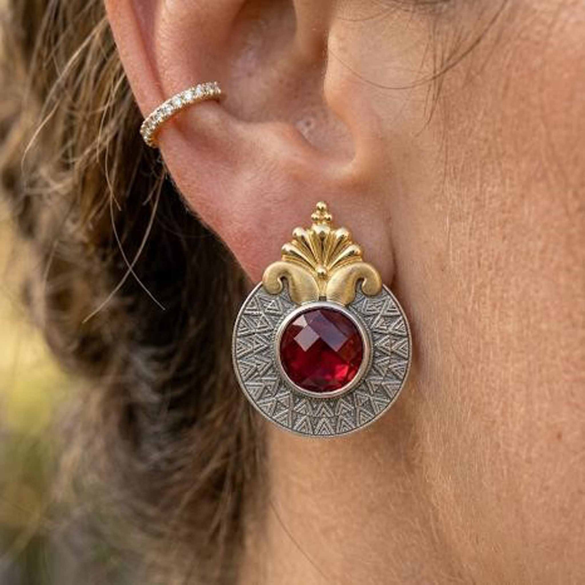 Detailed closeup of ruby dual tone statement earring