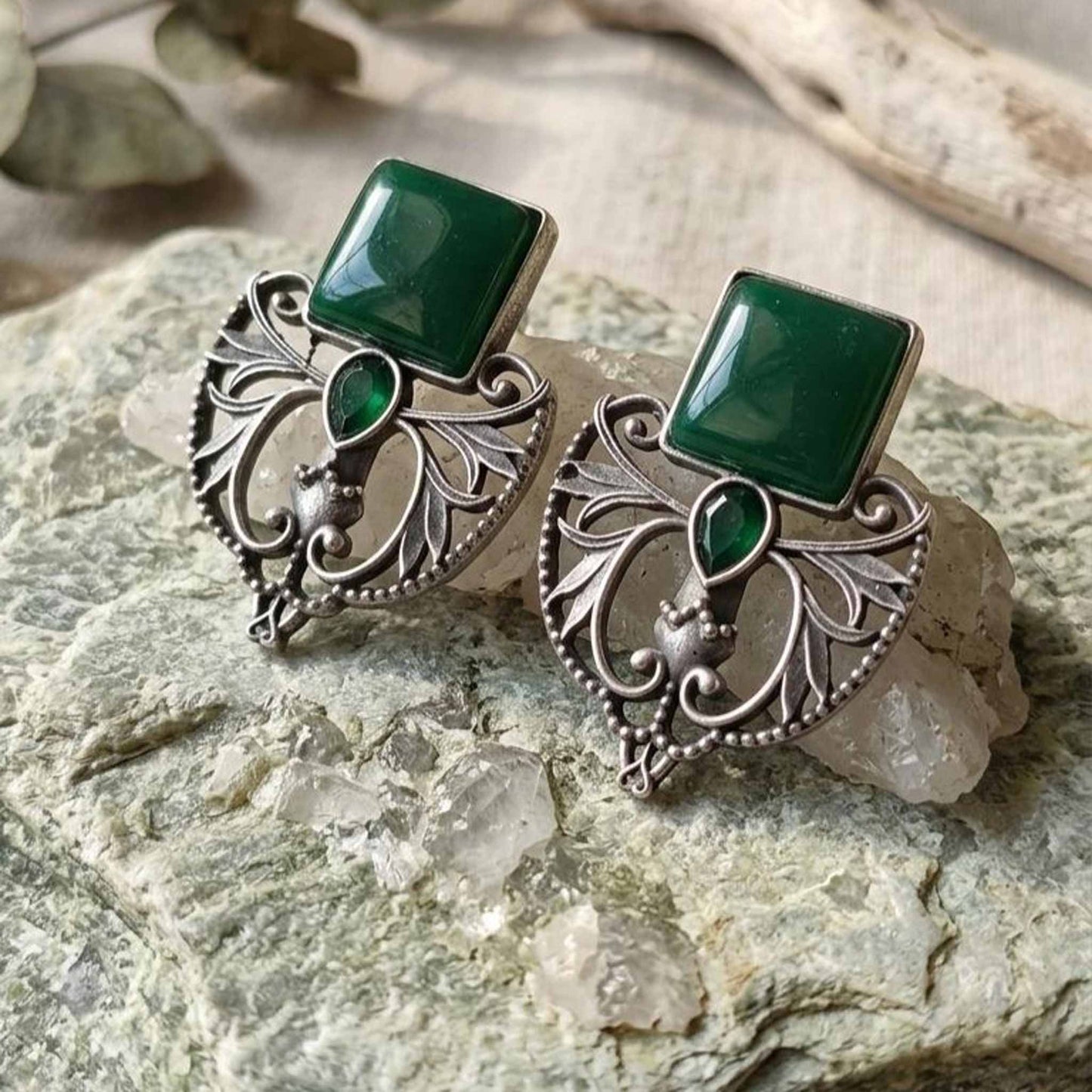 Green stone statement earrings on crystal backdrop