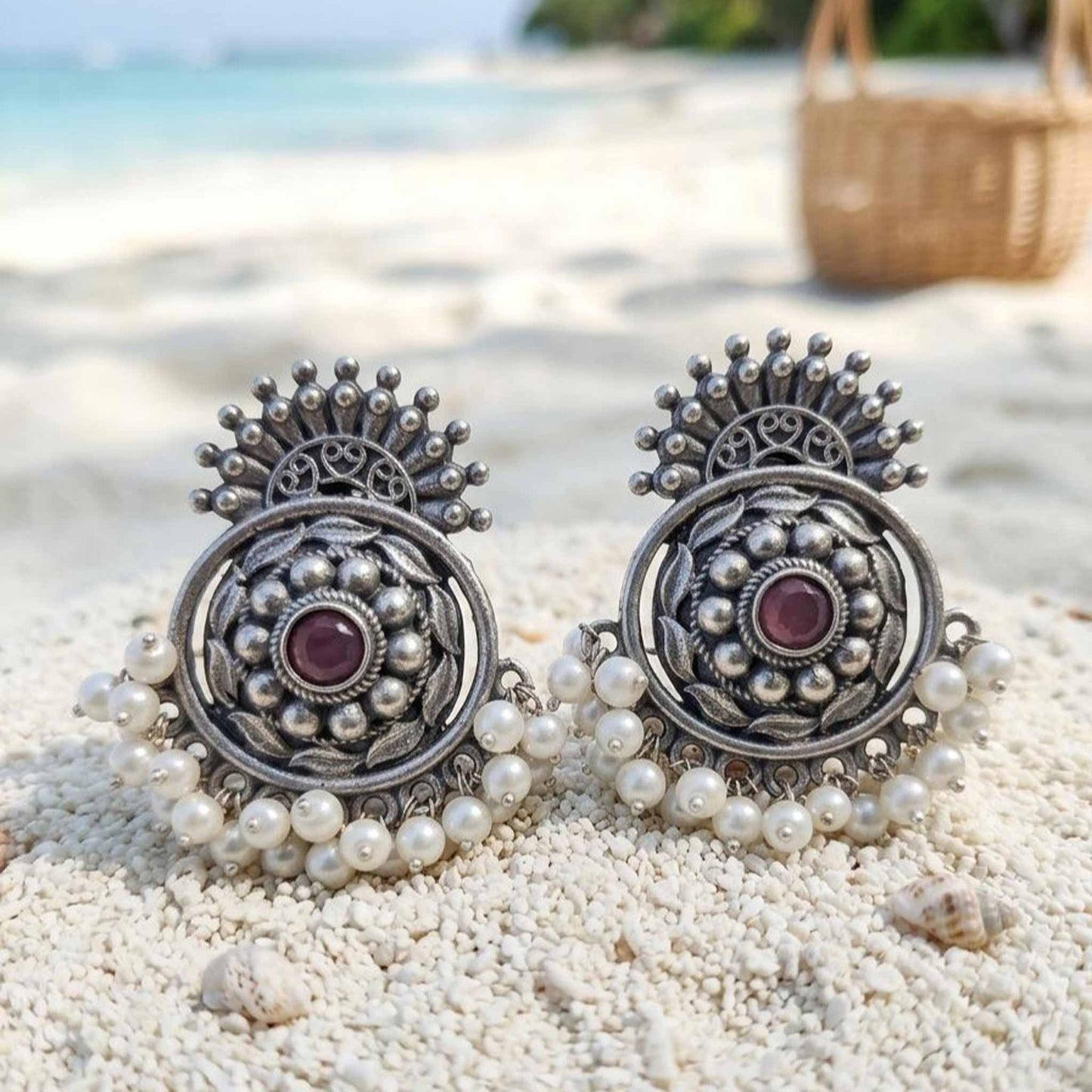 Pearl German Silver chandbali earrings displayed on beach sand