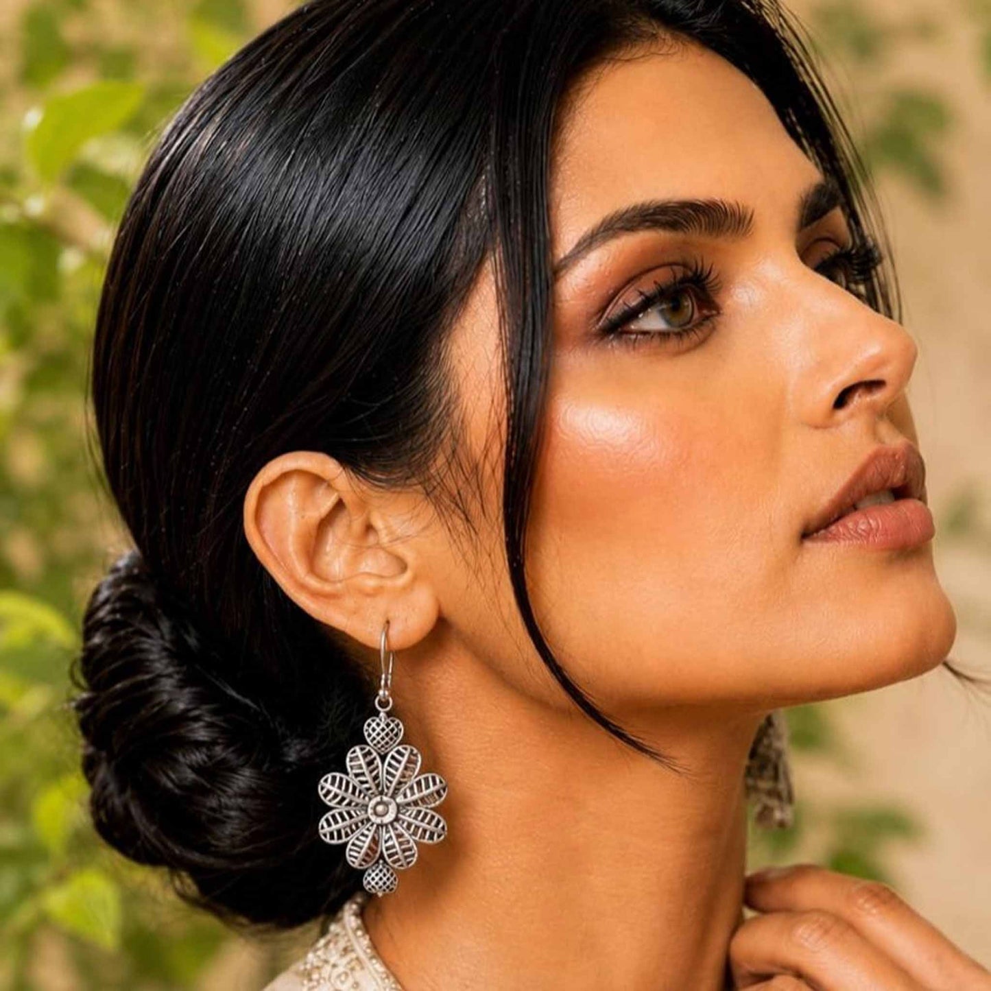Model wearing floral heart drop earrings