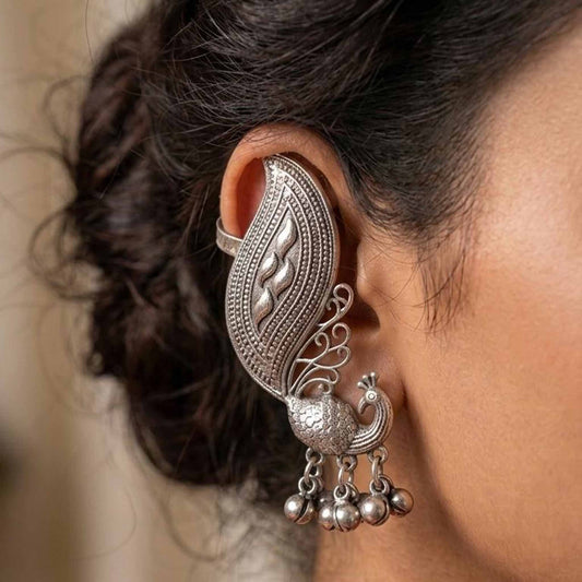 Woman wearing German Silver peacock ear cuff earrings