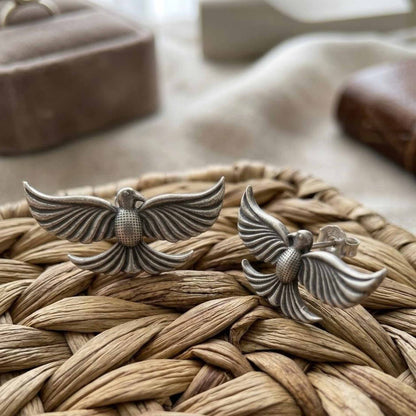 Back and side view of handcrafted bird stud earrings