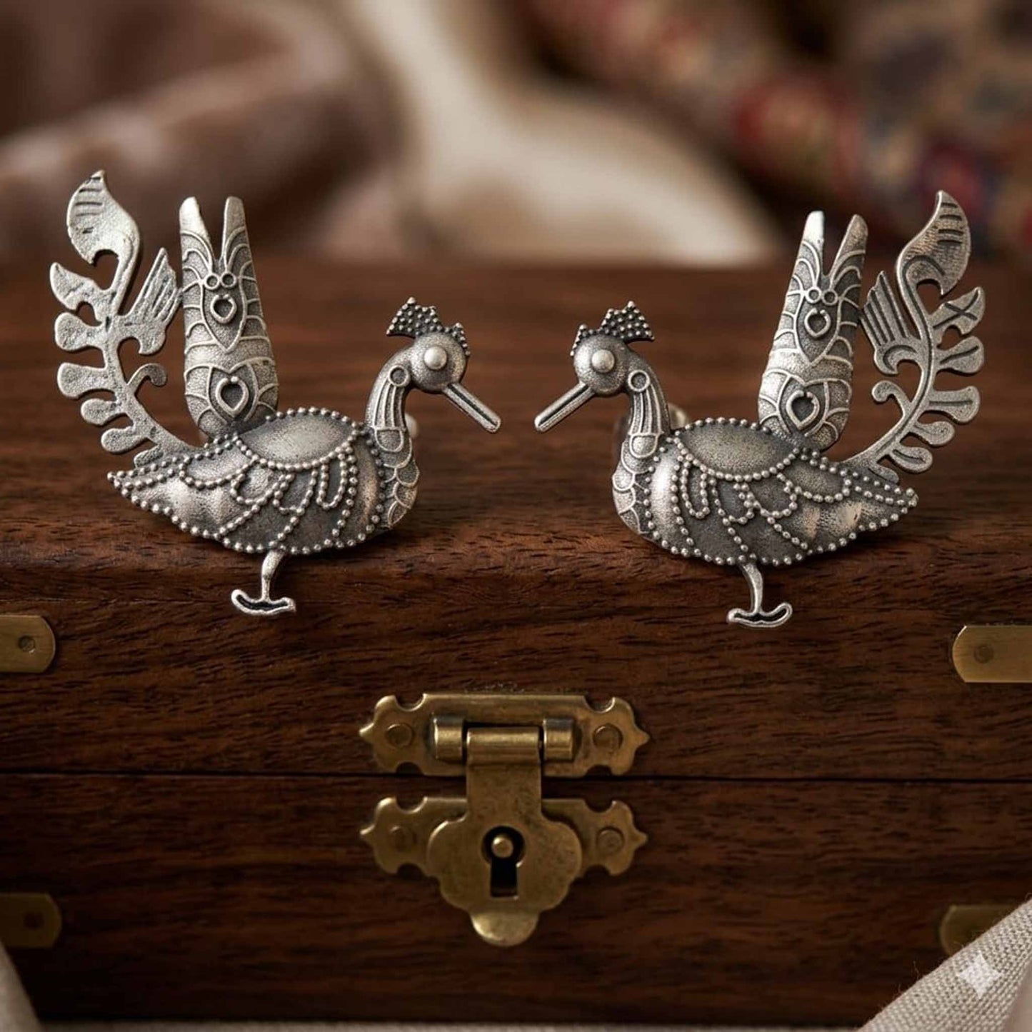 German Silver peacock statement earrings on wooden box