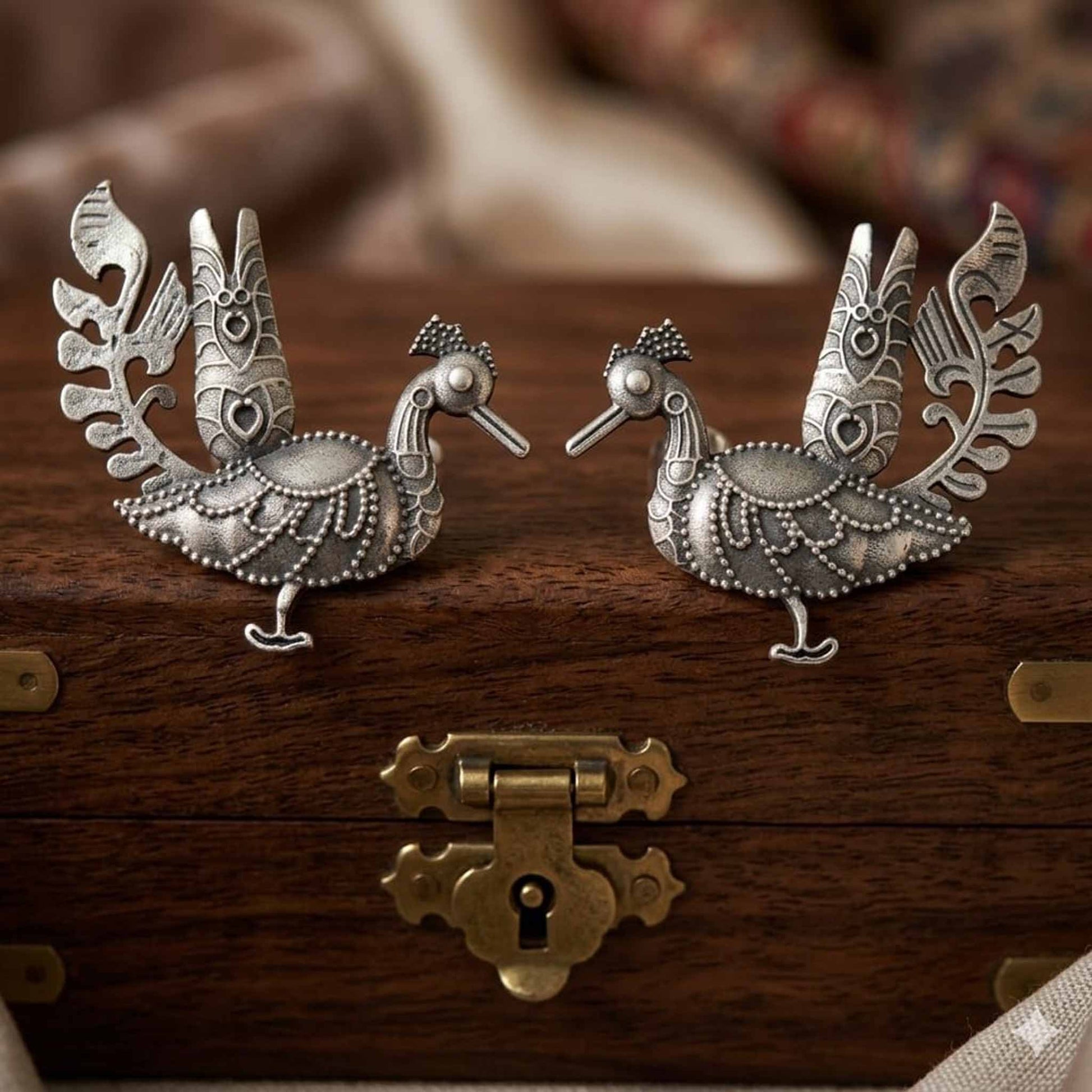 German Silver peacock statement earrings on wooden box