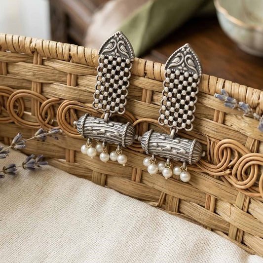 Heritage pearl dangler earrings displayed in woven basket