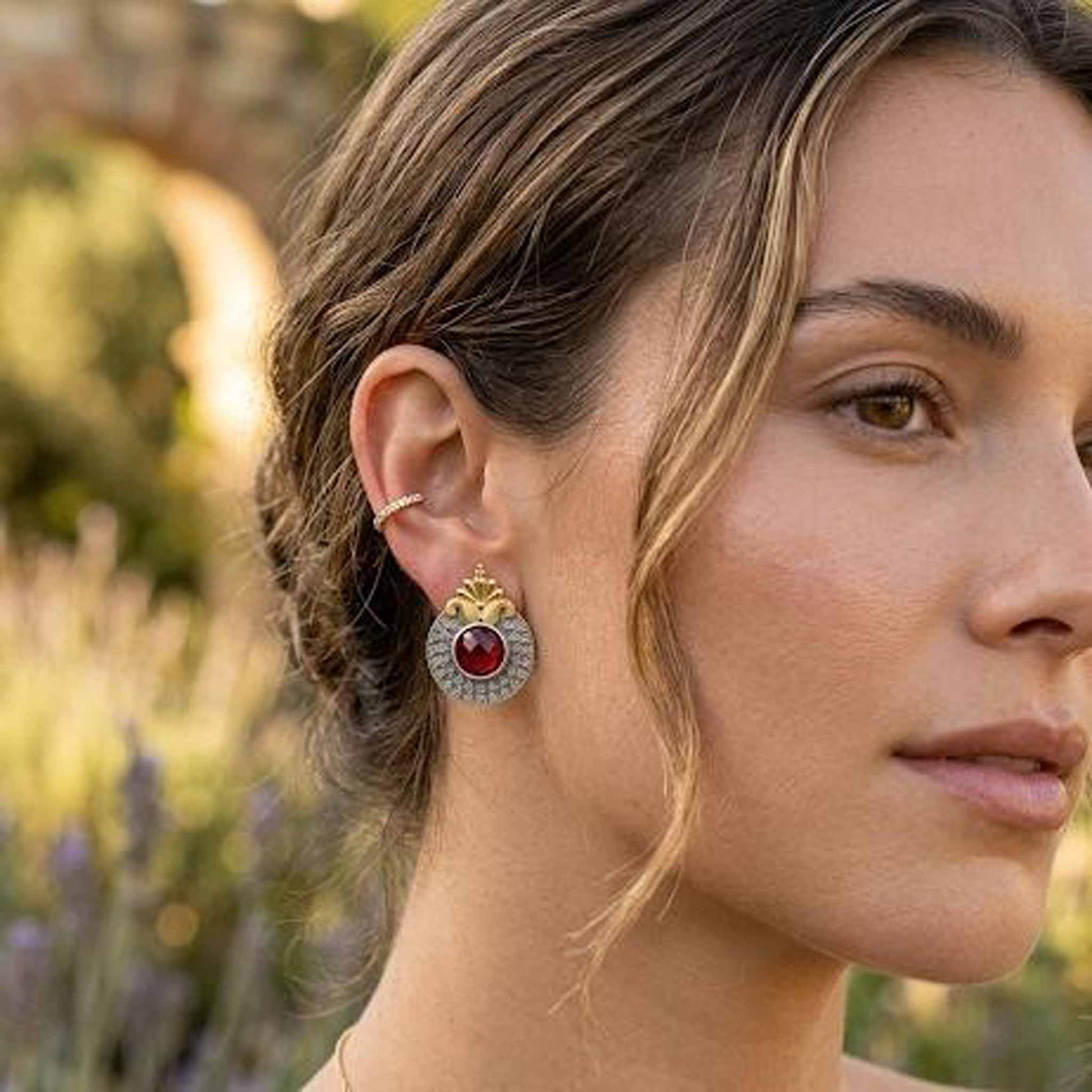 Woman wearing ruby dual tone ethnic earrings outdoors