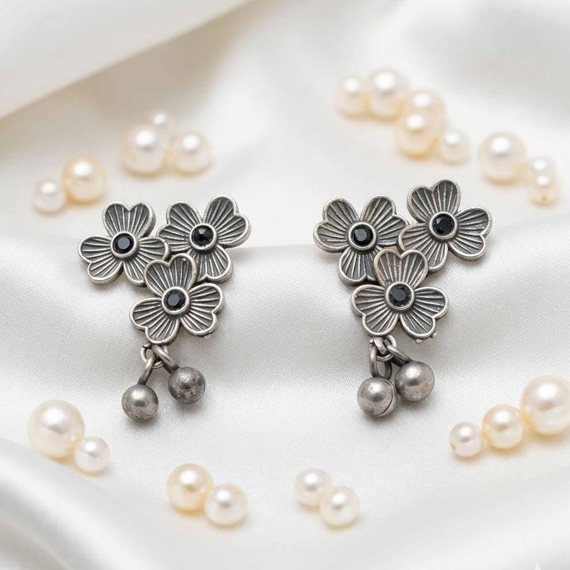 Three flower German silver stud earrings front view