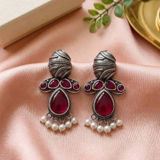 German Silver ruby drop pearl earrings on satin fabric