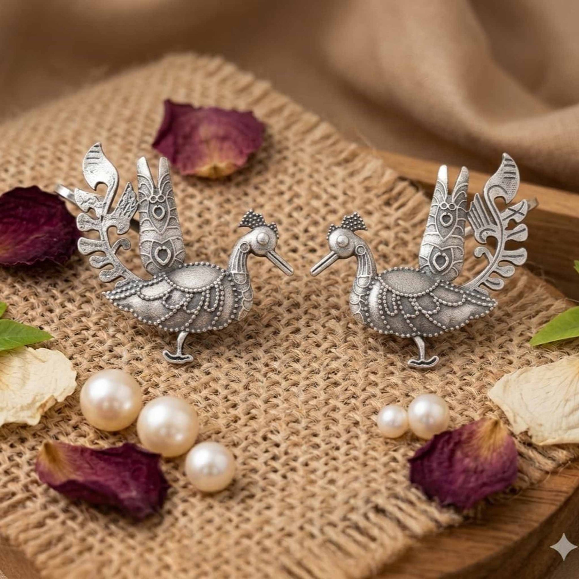 German Silver peacock ear cuff earrings on textured fabric
