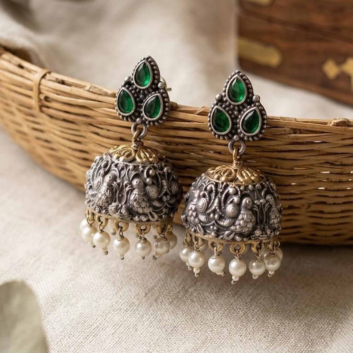 Emerald peacock embossed jhumka earrings with pearl drops