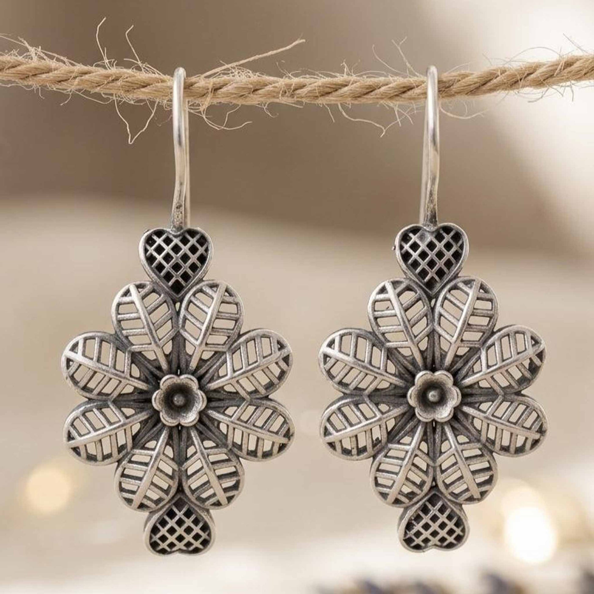 Closeup hanging floral heart earrings