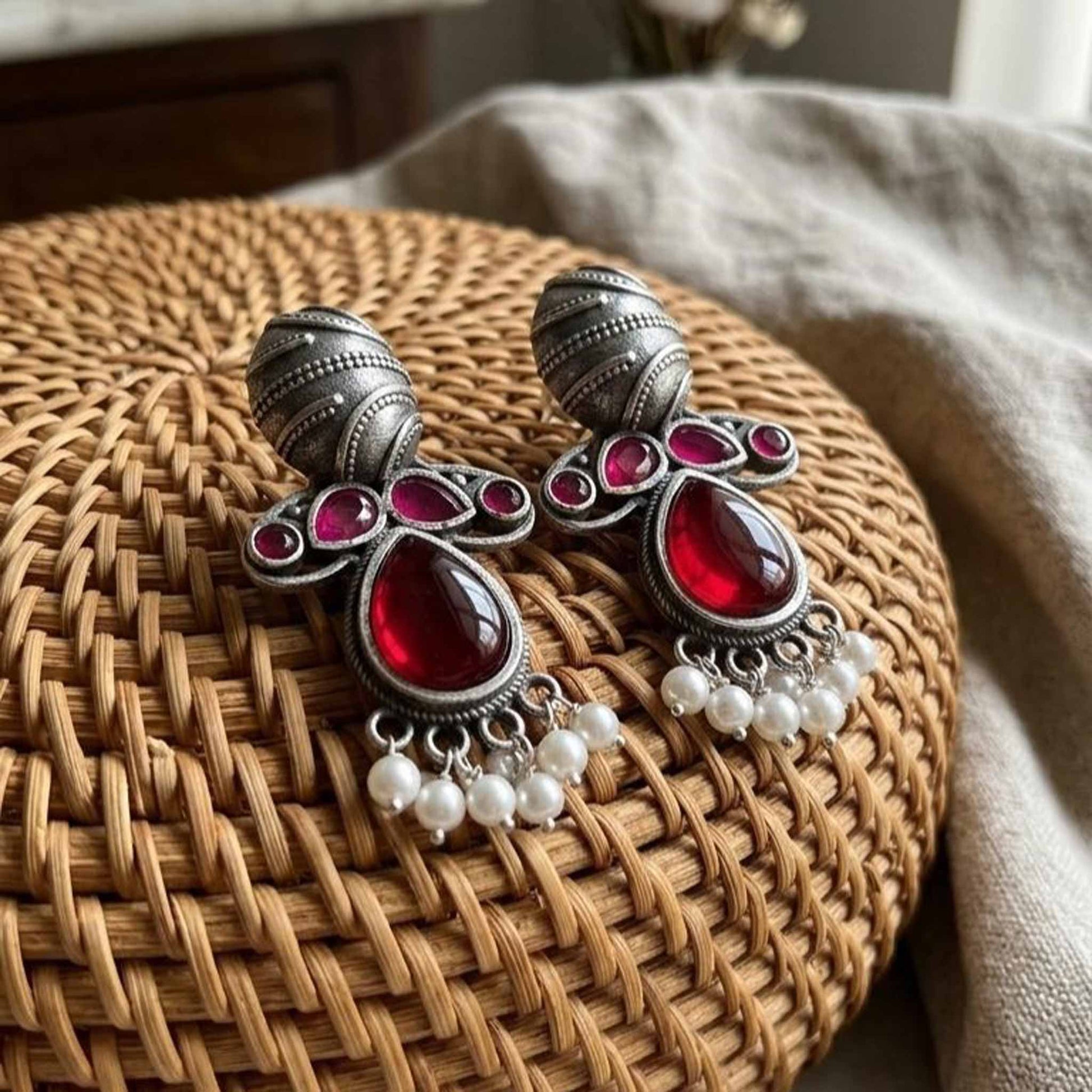 German Silver ruby pearl earrings on woven tray