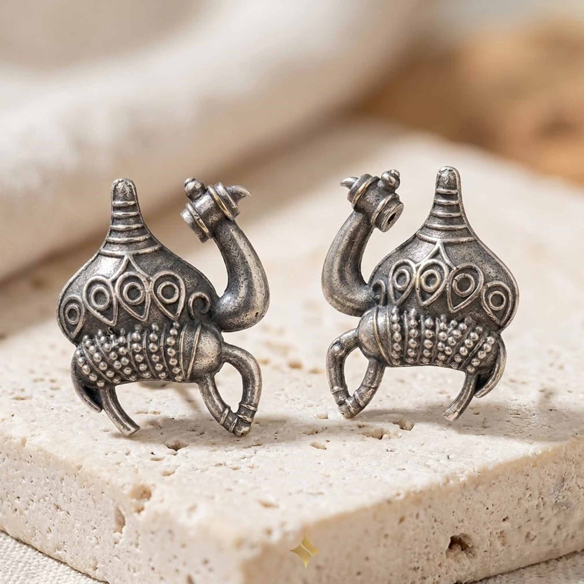 Silver camel motif stud earrings front product view