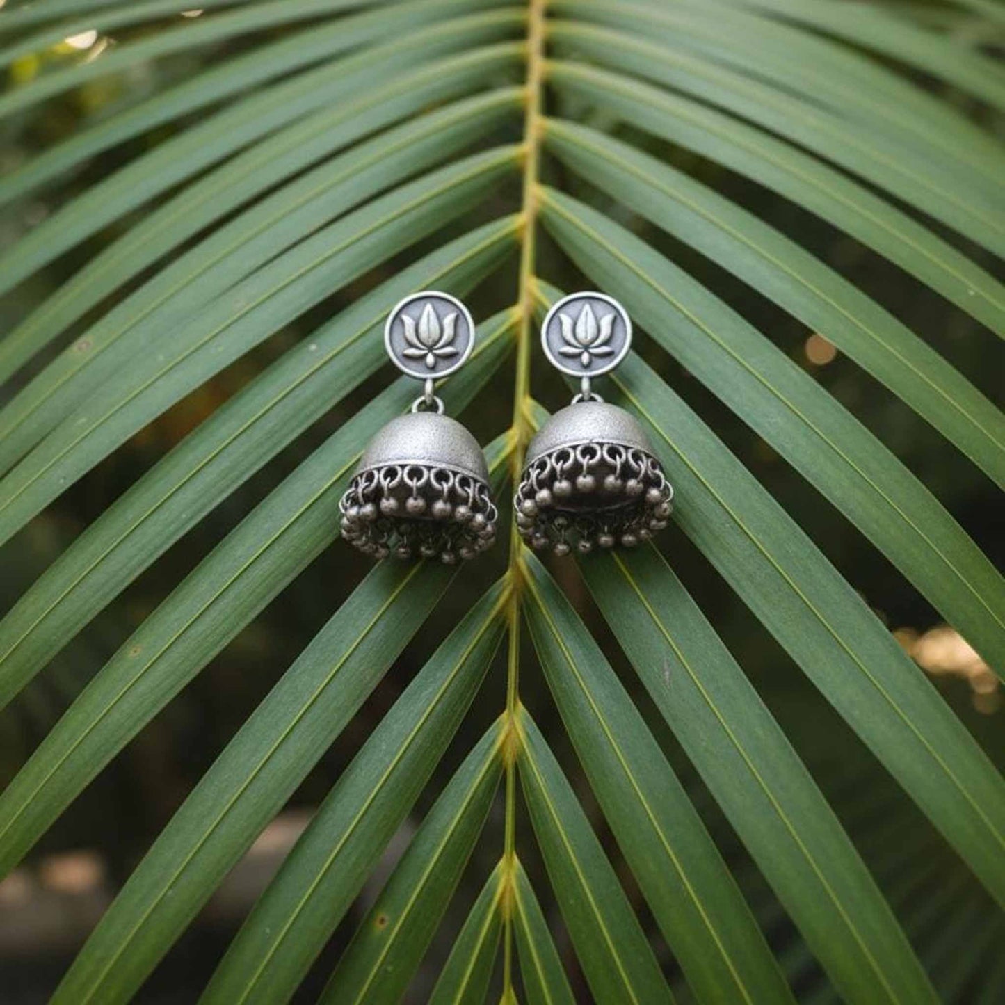 Lotus Motif German Silver Jhumka Earrings with Ghungroo Detailing